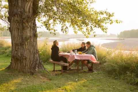 Family Road Trip: The author and her two sons playing cards at a campsite near Flat Head Lake in Montana | NextTribe